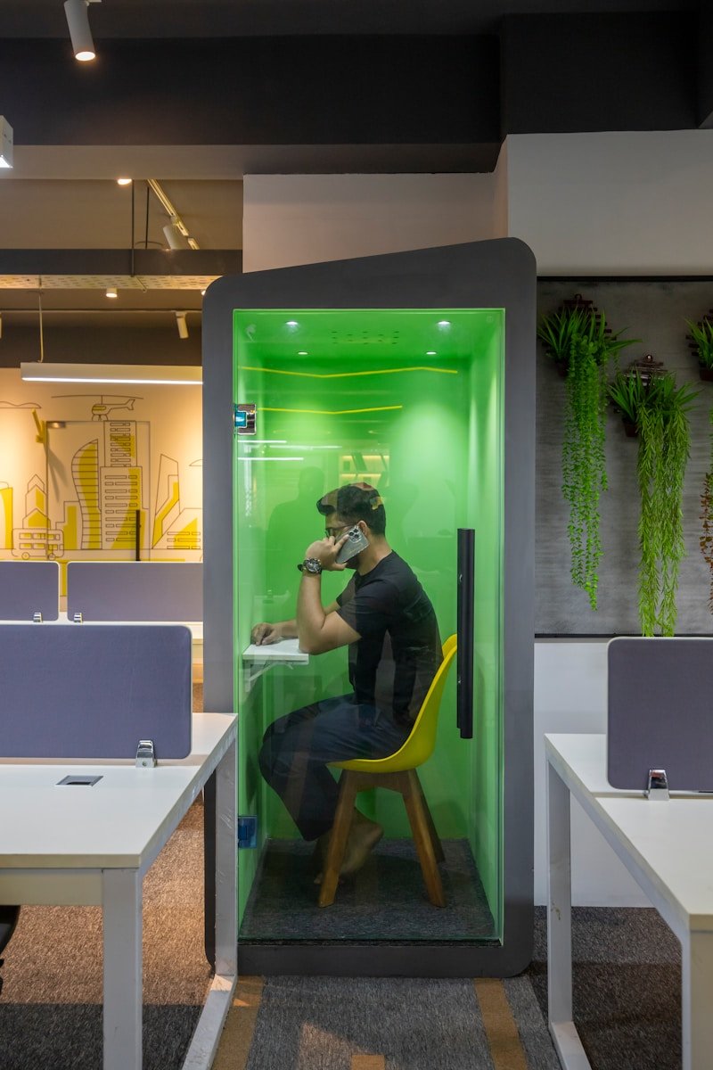a man sitting at a table in a green room